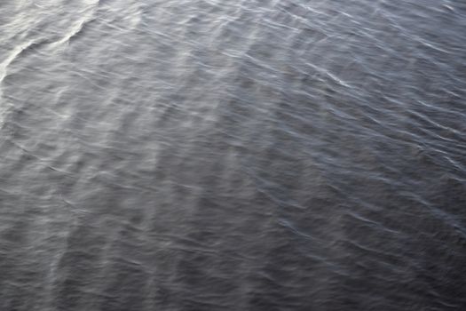 4 - Abstract background water texture, gentle and smooth water ripples. Outdoors reservoir lake, in natural daylight condition. Full frame image