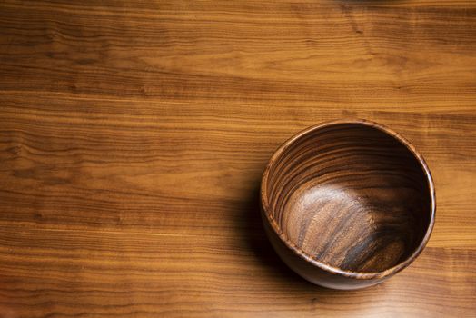 Bowl lying on a desk. Both created from walnut tree wood