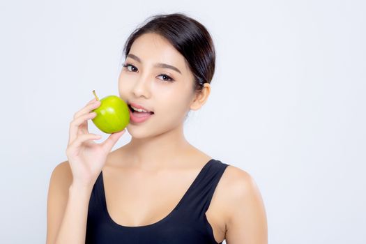 Portrait asian woman smiling holding and eating green apple fruit and beautiful body diet with fit isolated on white background, girl weight slim with cellulite or calories, health and wellness concept.