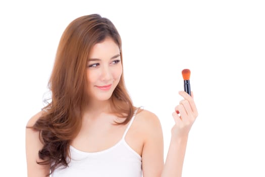 Beauty of portrait asian woman applying make up with brush of cheek isolated on white background, beautiful of girl holding blusher, skincare and cosmetic concept.