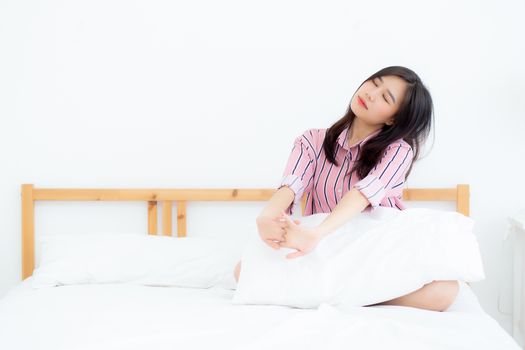 Beautiful of portrait young asian woman stretch and relax in bed after wake up morning at bedroom, new day and resting for wellness, lifestyle concept.