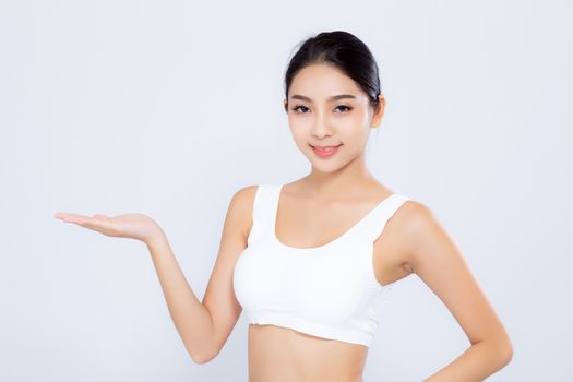 Portrait young asian woman smiling beautiful body diet with fit presenting something empty copy space on the hand isolated on white background, model girl weight slim with cellulite or calories, health and wellness concept.