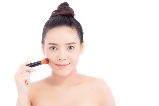 Beauty of portrait asian woman applying make up with brush of cheek isolated on white background, beautiful of girl holding blusher, skincare and cosmetic concept.