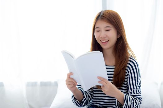 Beautiful of portrait young asian woman relax sitting reading book on bedroom at home, girl study literature, education and llifestyle concept.