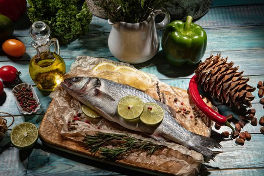 Fish and a bottle of oil on an old wooden desk