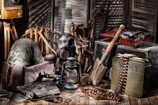 Old lantern, helmet, band with cartridges, camera and suitcase on a studio background