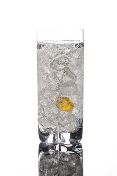 Crystals of ice in a glass with water on a glass background