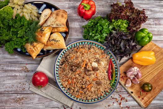 Asian traditional food and vegetables on an old wooden table