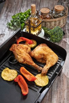 Roasted chicken and vegetables on a wooden table