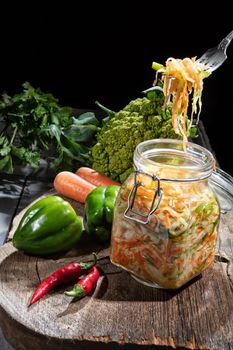 Cabbage and vegetables on an old wooden background