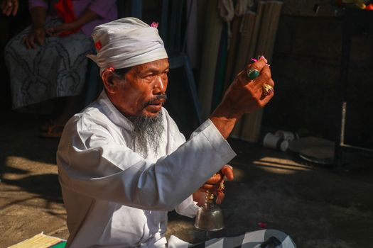 Close up of Hindu priest prays during a wedding ceremony. The pedanda performs wedding ceremonies.