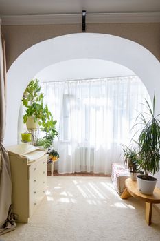 Exit from the room in the form of an arch to a spacious glazed balcony
