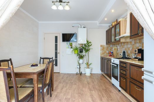 Interior of a spacious living room and kitchen with a classic wood grain design