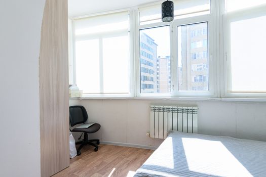 Fragment of a spacious inhabited insulated balcony with plastic windows