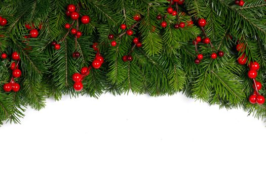 Christmas tree branches and red berries frame isolated on white background