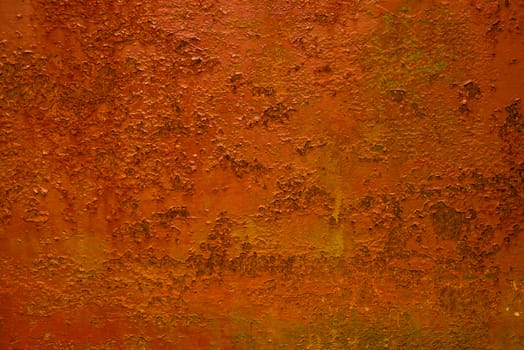 Abstract colorful image painted in orange on an outdoor rotten metal
