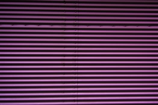 Abstract of a metal entrance in pink or purple colors
