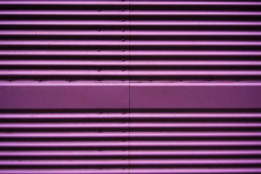 Abstract of a metal entrance in pink or purple colors in Prague, Czech Republic