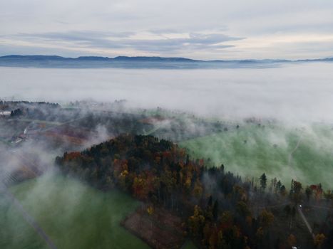 Panoramic foggy landscape with mountains in morning