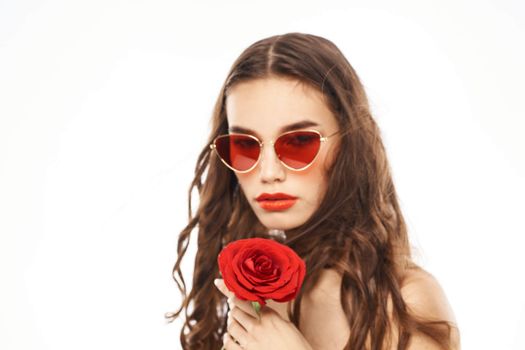 Brunette girl with red rose and sunglasses naked shoulders. High quality photo