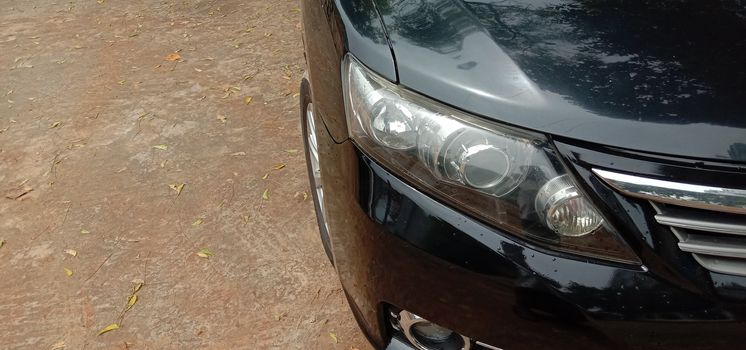 front side of black colored car on road