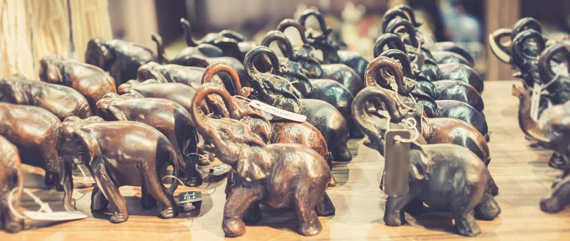 carved wooden small elephant sculpture decors in a shop at pinnawala sri lanka