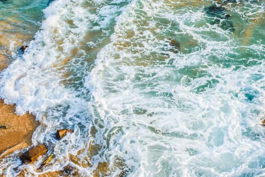 Sea tidal waves with white foam on galle sea bath beach