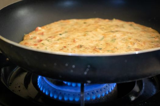 easy Egg-Oats omelette cooking on a pan