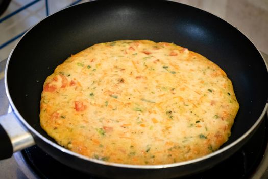 easy Egg-Oats omelette cooking on a pan