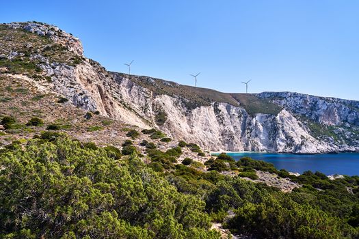 rocky coast and windmills on a hill on the island of Kefalonia in Greece