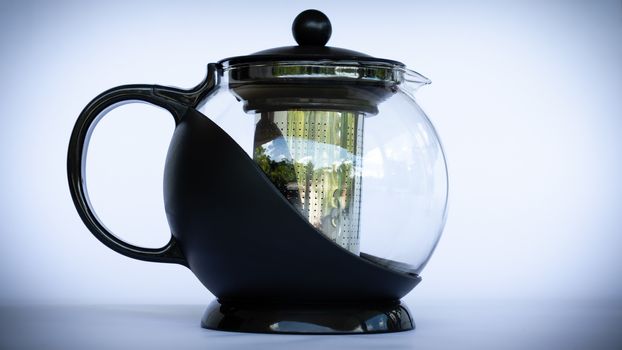 Black glass coffee pot in neutral background side view