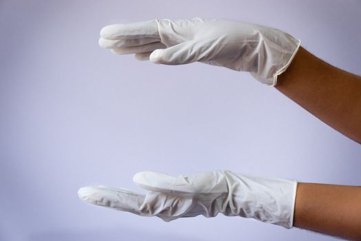 Female doctor wearing medical latex gloves in both hands