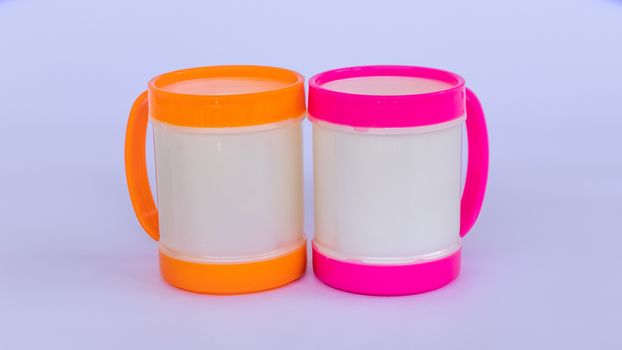Two colorful plastic coffee mugs on a white background