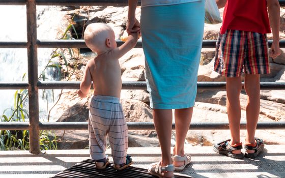 Small child Hand held by caring mother from behind photograph