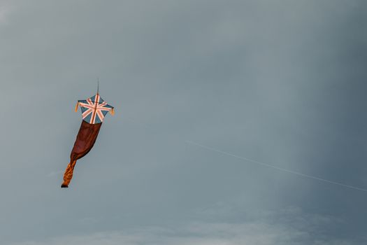 Kite fly against the dark moody sky