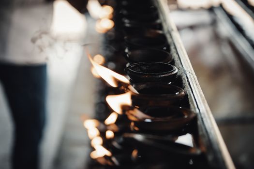 Burning clay oil lamps light flame close up