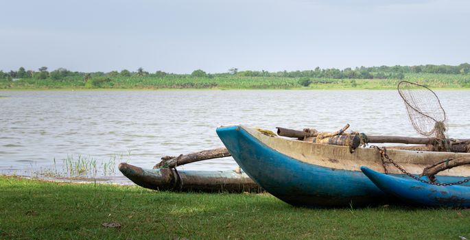 Traditional Sri Lankan wooden painted Fishing boat near the lake picturesque landscape photograph