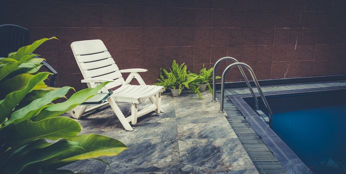 pool deck with white chair