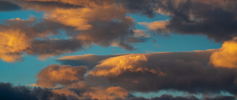 Panoramic view of dramatic colorful thunderclouds rising of sun floating in sky to change weather. Soft focus, motion blur meteorology cloudscape.