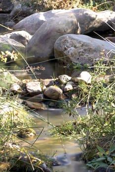 Small mountain river in sunny day, long exposure, silk effect