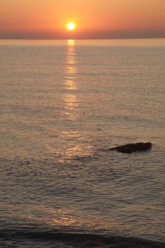 Sunrise on the rocky beach, Orange colors, lonely