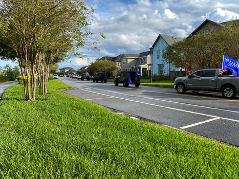 Orlando, FL/USA - 11/1/20:  A parade of cars honking and waving flags in the Laureate Park neighborhood in Orlando, Florida supporting the re-election of Donald Trump for President of the United States of America.