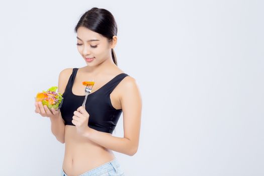 Beautiful portrait young asian woman smiling holding salad vegetable food isolated on white background, girl diet eating vegetarian for healthy, health care or wellness concept.