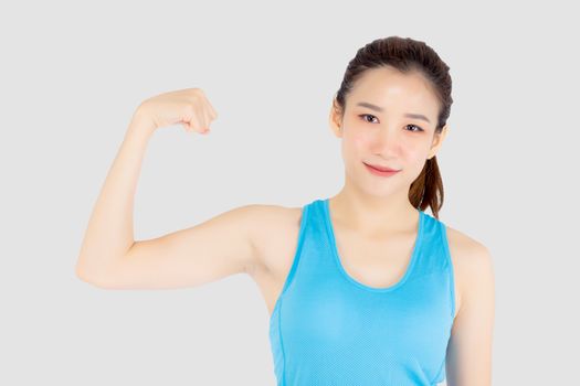 Beautiful portrait young asian woman wear sport clothes have strong and muscle with health, girl show biceps with exercise and workout for wellness isolated on white background, strength and fit concept.