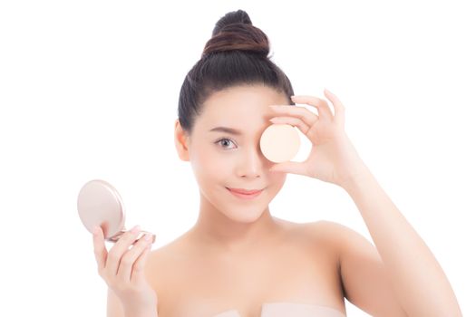 Portrait of beautiful asian woman applying powder puff at cheek makeup of cosmetic, beauty of girl with face smile isolated on white background, wellness and healthcare concept.