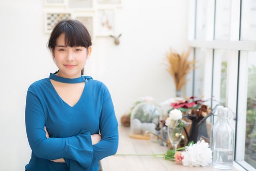 Beautiful portrait young asian woman smiling sitting at cafe, model girl happy with relax and resting looking camera, lifestyle concept.
