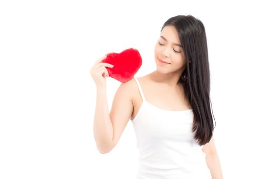 Portrait of beautiful asian young woman holding red heart shape pillow and smile isolated on white background, valentines day, holiday concept.