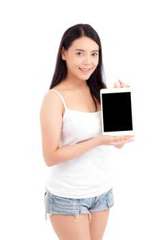 Portrait of asian young woman standing showing blank screen tablet isolated on white background, girl showing technology, business and communication concept.