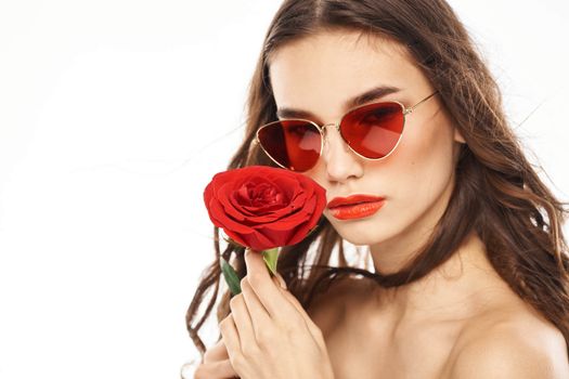 Brunette girl with red rose and sunglasses naked shoulders. High quality photo