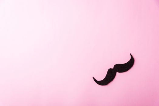 Black mustache paper, studio shot isolated on pink background, Prostate cancer awareness month, Fathers day, minimal November moustache concept